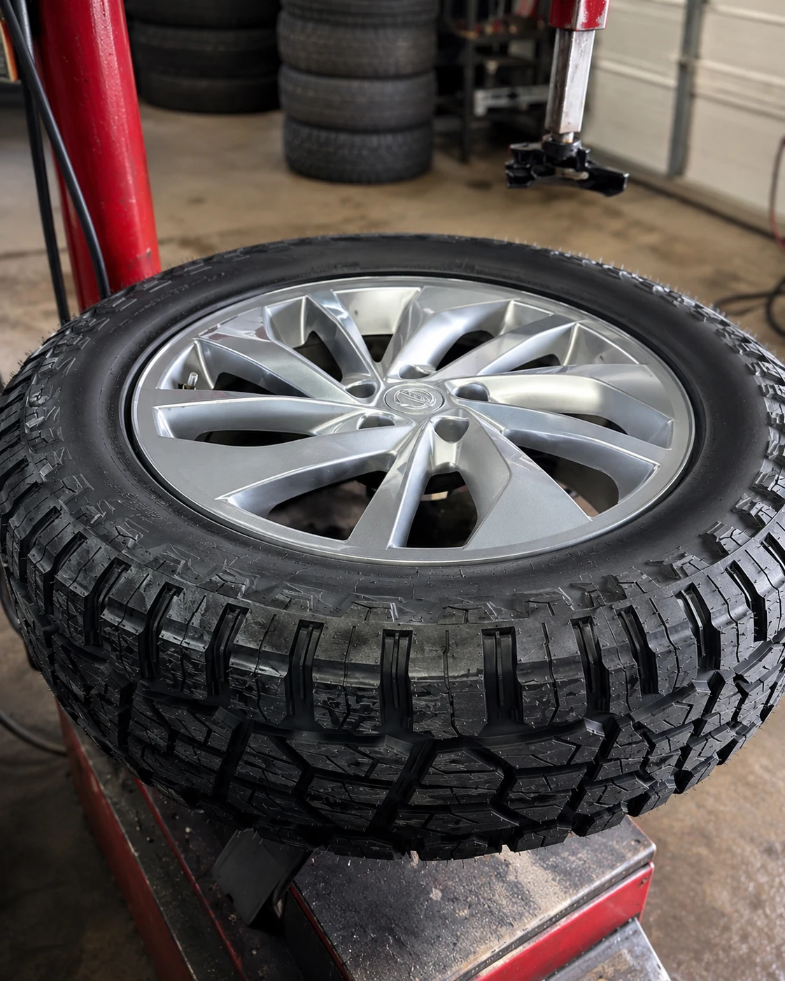Tire mounted on a wheel at Nick's Tire & Auto on the tire changer machine during installation
