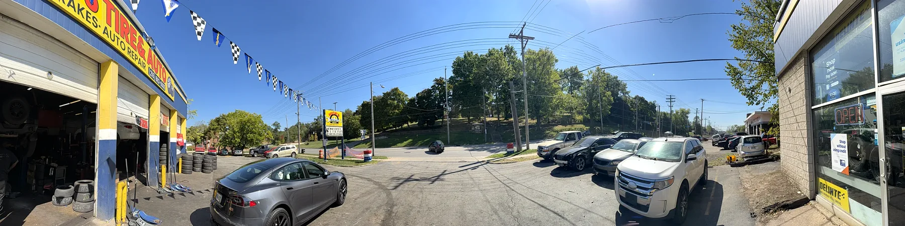 Panoramic view of Nick's Tire & Auto on Euclid Ave Cleveland — full lot, multiple bays, real working shop